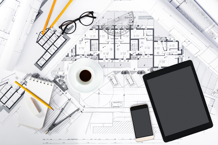 Top View of Construction plans with Tablet, smartphone and drawing Tools on blueprints; Architectural and Engineering Housing Concept.の写真素材
