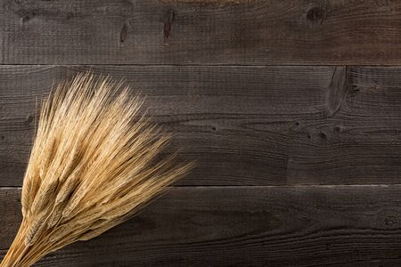Ears of wheat on rustic wooden backgroundの写真素材