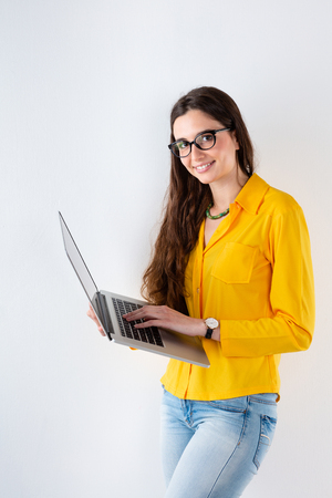 Portrait of smiling Young beautiful woman studying and using computerの写真素材