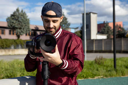Video operator focusing with his video camera. Cinema lens on DLSR camera