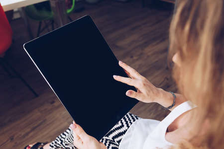 Young girl using a big tablet with touch gesture & pointing finger tap simulation in a smart moder...