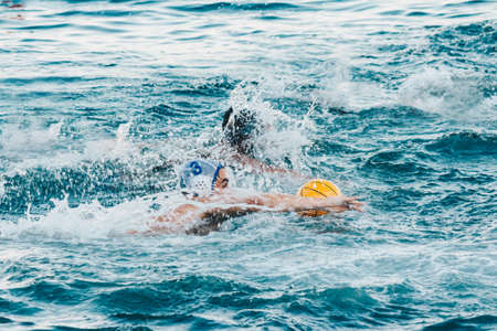 Players fighting for the ball in the sea.の写真素材