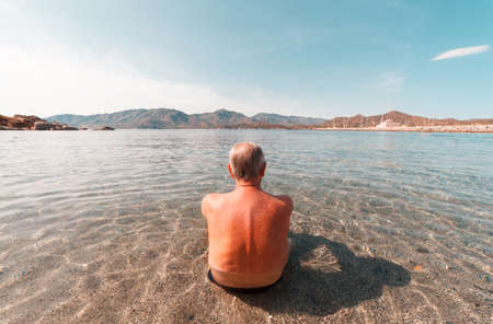 aged man taking rest at the sea in Italyの写真素材