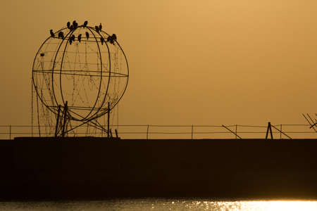the port of salonicco at sunset with an art installation on the backgroundの写真素材
