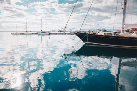 Cagliari, Italy - DEC - 2017  Boats at harbor in a sunny day with reflections on the water - clear sky on the backgroundのeditorial素材