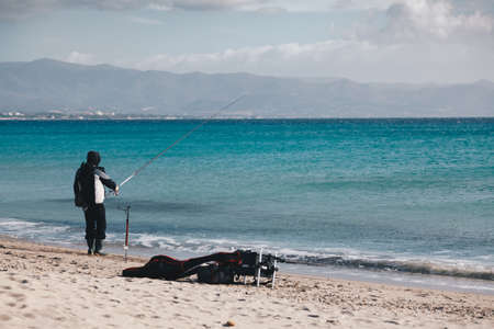 fischerman on the beach in the capital of Sardinia in a sunny dayの写真素材