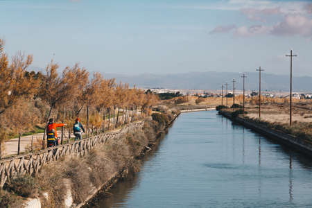 A bikers family runnig along the channel on the Molentargius Regional Park - Sardinia Italy.の写真素材