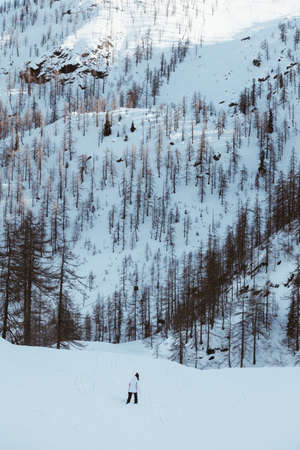 Alone woman walking on the snow into the wild on winter season.の写真素材