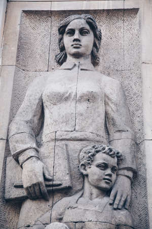 WARSAW, POLAND - March 2018 - A social realist relief of a socialist woman and kid in the center of Polish capitalのeditorial素材