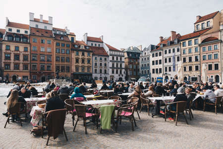 WARSAW, POLAND - March 2018 - Tourists taking rest in front of the Royal Castle on the Old Town in Warsaw, Poland.のeditorial素材