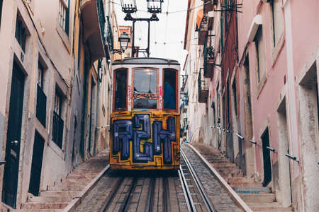 LISBON, PORTUGAL - April 2018 Vintage yellow tram with graffiti journey passing thorough old Town. Lisbon - Portugal - Cityscapeのeditorial素材