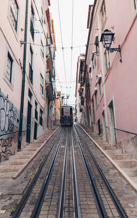 LISBON, PORTUGAL - April 2018 Vintage yellow tram with graffiti journey passing thorough old Town. Lisbon - Portugal - Cityscapeのeditorial素材