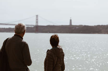 Senior Man and young girl looking the bridge in Lisbon - Portugal - travel family conceptの写真素材