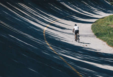 Biker with Mountain bike along Path in old racetrack, speedway parabolic in the Autodrome of Monza - Lombardy - Italyの写真素材