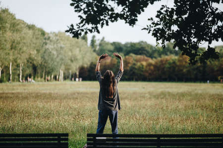 Senior woman practicing yoga at the park in italy.の写真素材