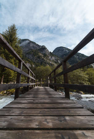 wood bridge in mountain in val di mello - sondrio italyの写真素材