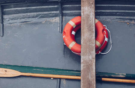 close up of a old little boat with buoy orange - life ring - marine mood