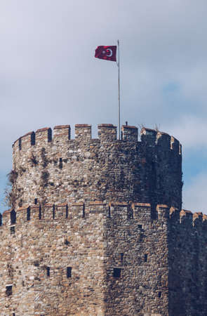 old tower of the medieval fortification in istanbul with national flag. turkeyの写真素材