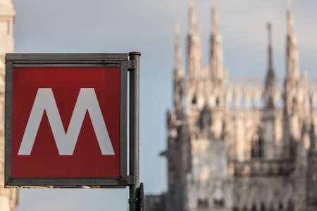 sign metro station in Milan Italy with blurred church on the background
