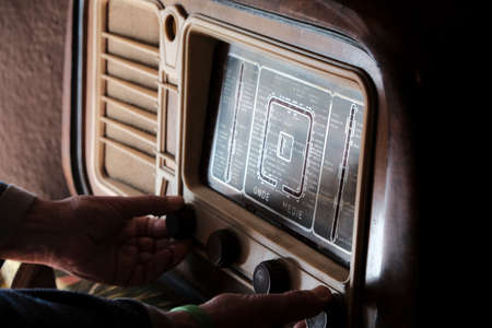 hands using vintage old radio