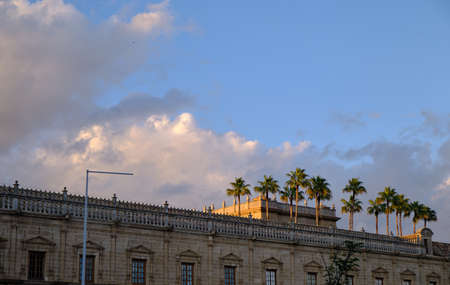 view of the Old Hospital of the Five Wounds at sunset with palms tree - Seville Spainの写真素材