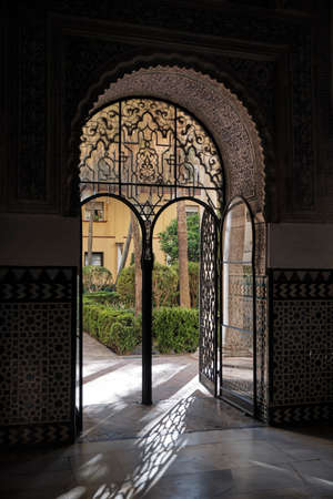 April 2019 - Seville Spain - Interior view of courtyard of Royal Alcazar with plant in the center of the roomのeditorial素材