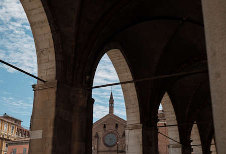 view if the Church of St. Francesco from covered walkway in a sunny day. Piacenza. Emilia-Romagna. Italy.の写真素材