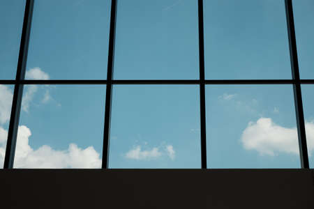 view through modern window architecture of sky in a sunny day with clouds in Milan. - business...