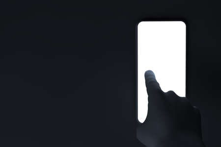 3D illustration or 3D rendering - view of hand man finger tapping smart-phone with white light in dark space or room - technology conceptの写真素材