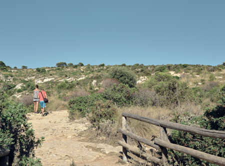 tow peoples a boy and a girl doing trekking or hiking along the touristic path of (sella del...