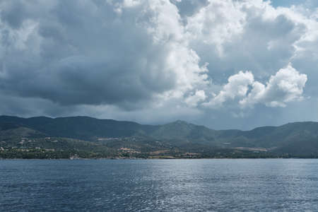Seascape panorama from little boat in a cloudy day along the shoreline in sardiniaの写真素材