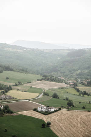 Aerial view of countryside with hills and farm in the small village of Italian name: Zavattarello...