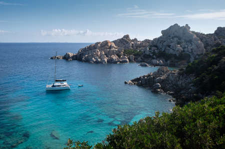 little old boat anchored in a turquoise of Cala Spinosa - bay in the La Maddalena Archipelago - sardinia travel destinationの写真素材