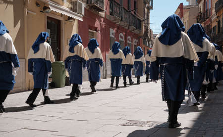 APRIL - ITALY 2022 - group of people with traditional Religion dress during Ceremony during easter - Cagliari Sardiniaのeditorial素材