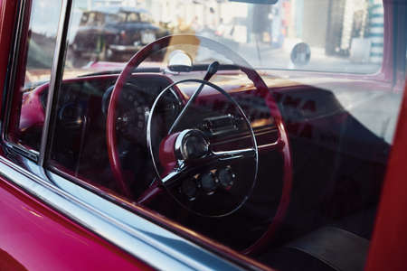 Retro car Cockpit parked in the old street of the European city.の写真素材