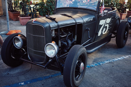 JULY ITALY - Milan 2022 Retro car Hot Rod parked in the old street of the European city.