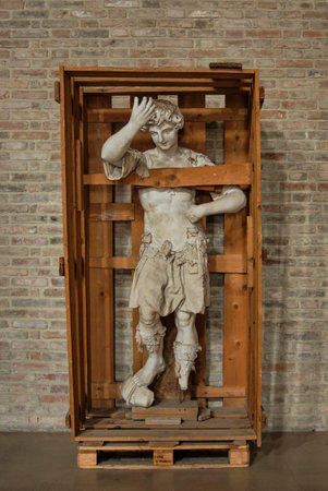 statue ready for restoration and protected by a wooden boxのeditorial素材