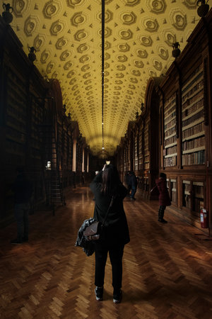 2023 FEB - ITA - girlo taking photo at the Palatine Library in the Palazzo della Pilotta, Parma,...