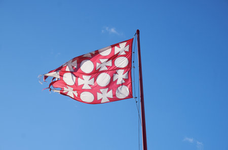Hungarian national flag unfurling proudly: red background adorned with iconic circles and crosses, embodying national identity and heritageの写真素材