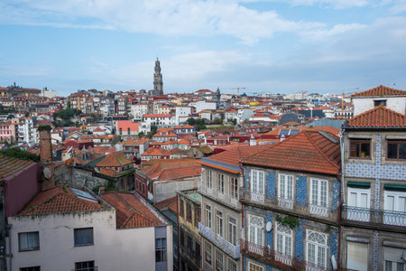Panoramic view of Porto, Portugal, showcasing a mix of traditional and modern architecture. The historic buildings with red-tiled roofs stand in contrast with the modern structures,の写真素材