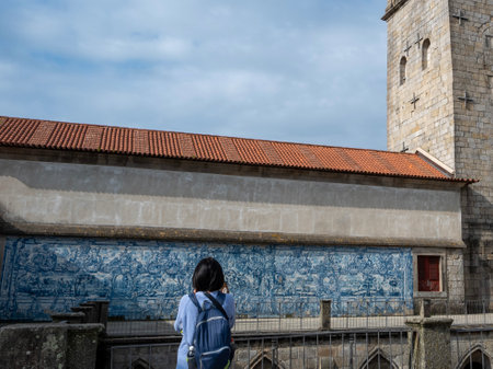 Azulejo Panel in Porto Cathedral with Tourist Girl Photographingの写真素材