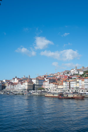 A Scenic View of the River and the Historic Old City of Porto in Portugal, Showcasing Beautiful Architecture and Waterfront Charmの写真素材