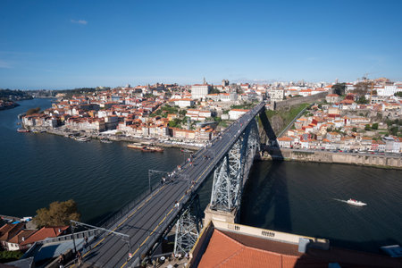 Panoramic view of Porto, featuring the river, iconic bridge, and the historic old town. A stunning scene showcasing the city's rich history and vibrant atmosphere.の写真素材