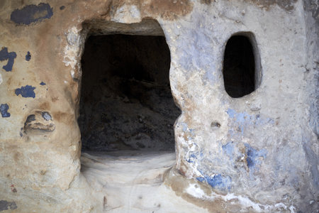Historic rock-cut house entrance in Uplistsikhe, Georgia. Features Stone, Cave, Ancient architecture, and Archaeological heritage.の写真素材