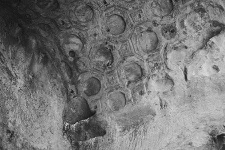 Detailed ceiling decorations in Uplistsikhe, Georgia. Showcases Stone, Ancient design, Carved patterns, and Cultural heritage.の写真素材