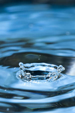 Bouncing water drops in blue backgroundの写真素材