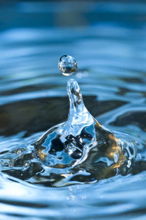 Bouncing water drops in blue backgroundの写真素材