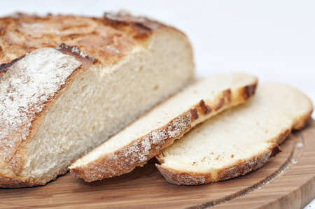 Slices of bread on a wooden plateの写真素材