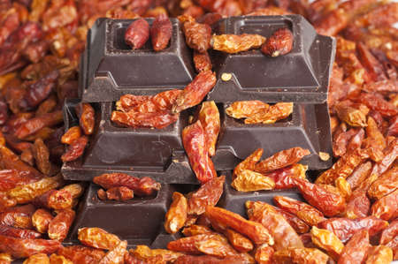 Chocolate blocks and red hot peppersの写真素材