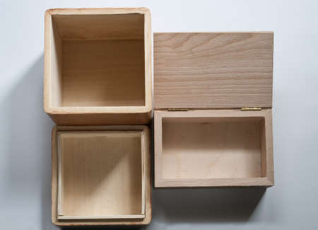 Two empty open wooden boxes on white background